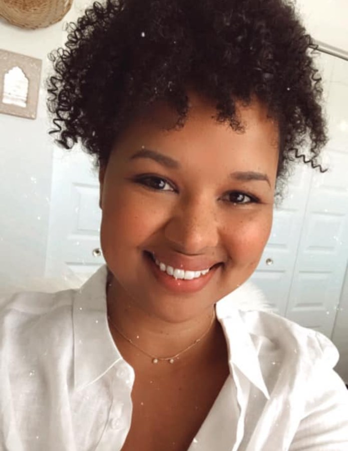 Michelle smiling in a white shirt